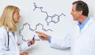 Dr. Martinsen and Dr. Chalmers discussing melatonin and omega-3 at the whiteboard