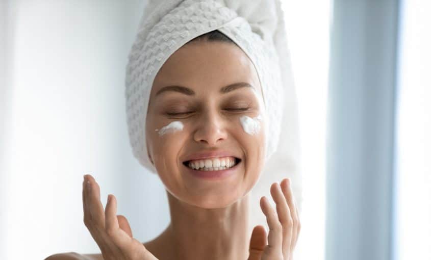 a woman with moisturizer on her face